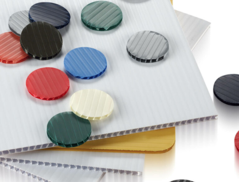 sheets and rounds of Fluted Polypropylene Boards in varying colors stacked