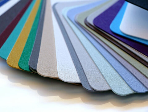 KYDEX® Thermoplastic sheets in various colors stacked and fanned out