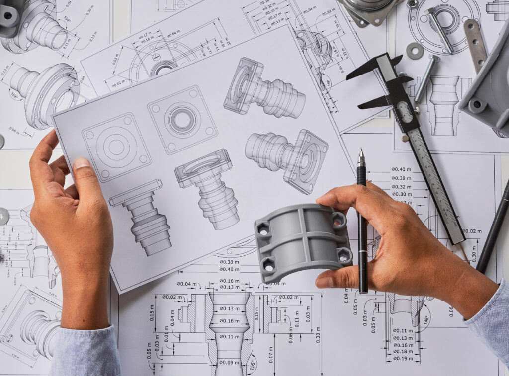 Engineer technician designing drawings of mechanical parts