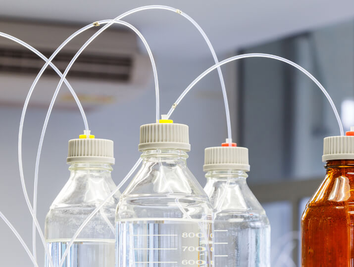 several PTFE tubes coming out of the top of bottles