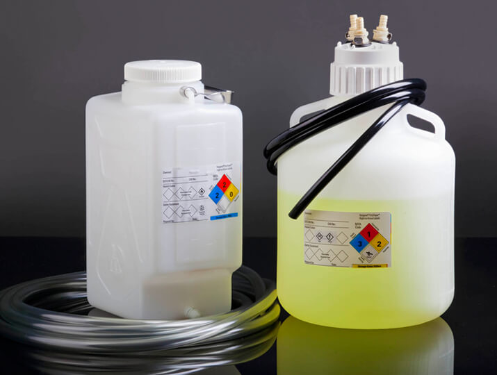 Vinyl Tubing wrapped around two large bottles of chemicals
