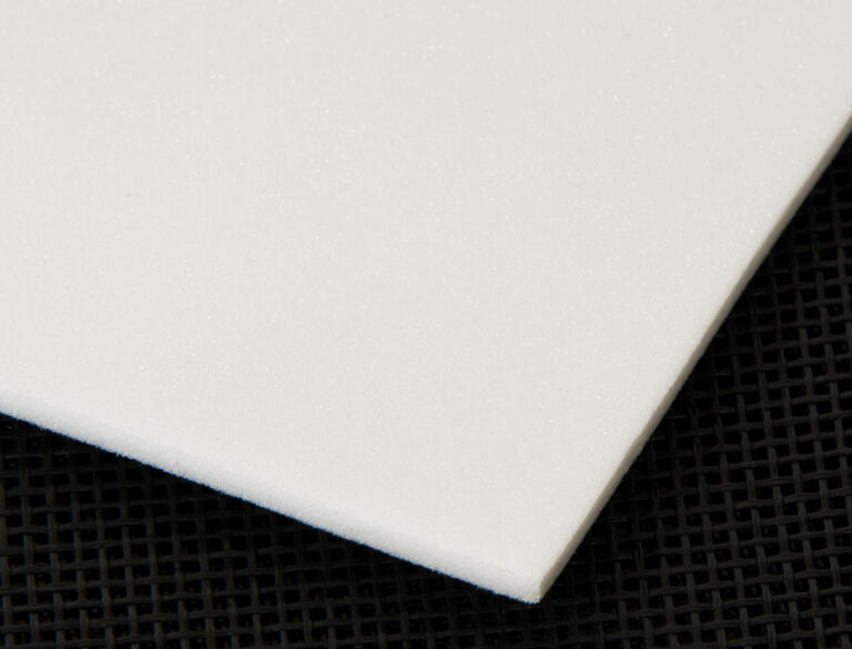 single sheet of white foam padding on a black background