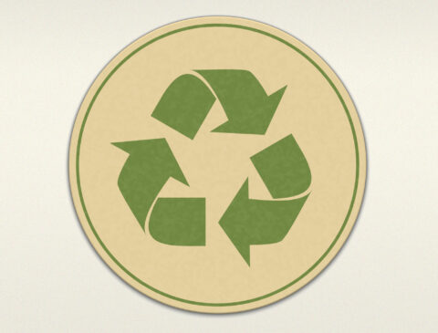 green recycling symbol on tan background