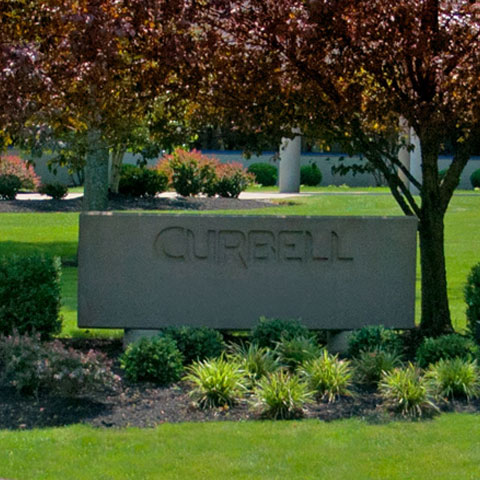 Curbell outdoor sign in a landscaped setting