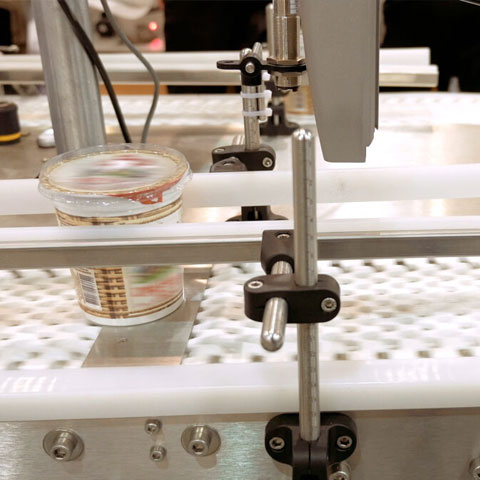 Industrial machine processing conveying yogurt containers